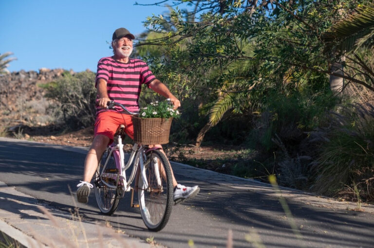 Happy senior man riding a bicycle.
